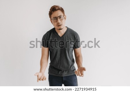 Angry and mad asian gangster with color hair and eyeglasses in black t-shirt.