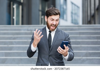 Angry Male Businessman Cry Talking On The Phone Outside Business Man Shouting On Call Outdoors. Nervous Mad Professional Conversation On Smartphone. Irritated Employee Scream Speak At Urban Street