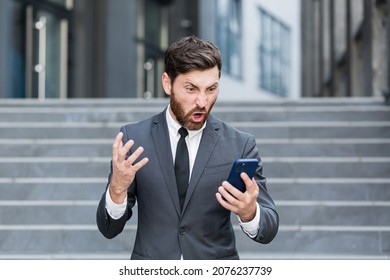 Angry Male Businessman Cry Talking On The Phone Outside Business Man Shouting On Call Outdoors. Nervous Mad Professional Conversation On Smartphone. Irritated Employee Scream Speak At Urban Street