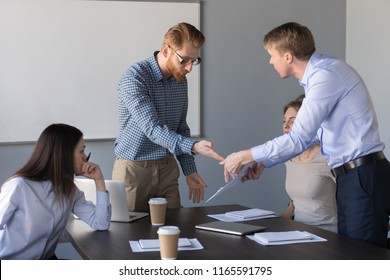 Angry Male Colleagues Argue Over Contract Conditions During Company Business Meeting, Mad Workers Dispute About Document Terms, Millennial Businessman Disagree With Coworker On Paperwork Issue