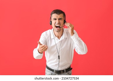 Angry Male Consultant Of Call Center With Headset On Red Background