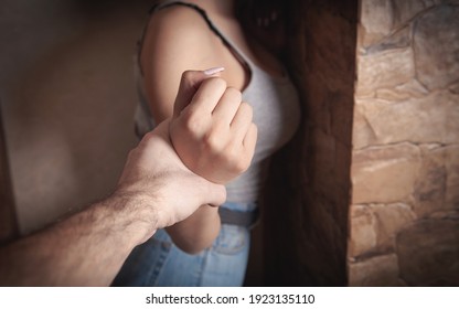 Angry Male Hand Holding A Woman Hand. Abuse Victim