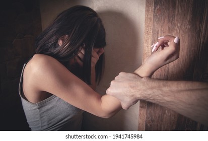 Angry male hand holding a woman hand. Abuse victim