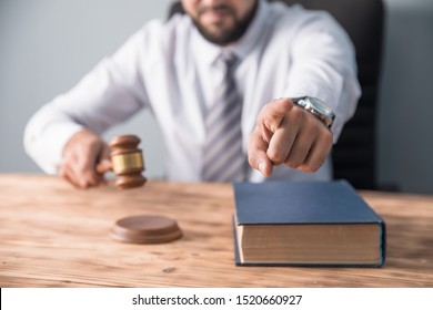 Angry Male Judge Hand Gavel On Desk
