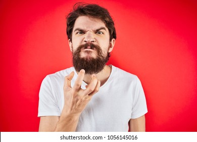  Angry Man With A Beard Holds Hand The Free Space On A Red Background                              
