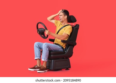 Angry man in car seat and with steering wheel on color background