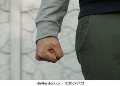 Angry man with clenched fist against white wall, closeup - Shutterstock ID 2185893773