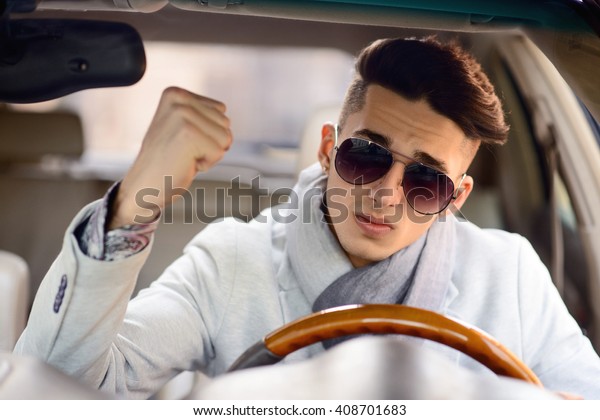 angry man driving a\
car