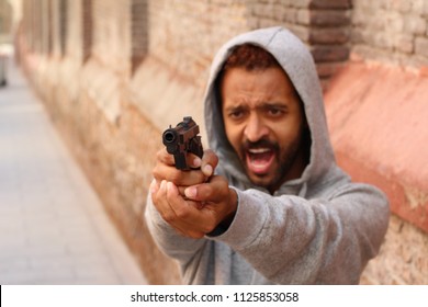 Angry Man Holding A Gun And Screaming