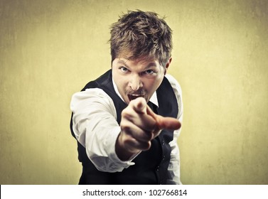 Angry man pointing his finger against somebody