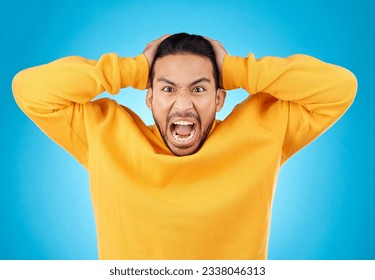 Angry, man and portrait with screaming in studio with burnout, anxiety and stress. Mental health, blue background and frustrated male person with yelling with anger about problem, mistake and issue - Powered by Shutterstock