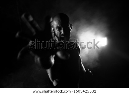 Angry man screaming at camera, long exposure effect