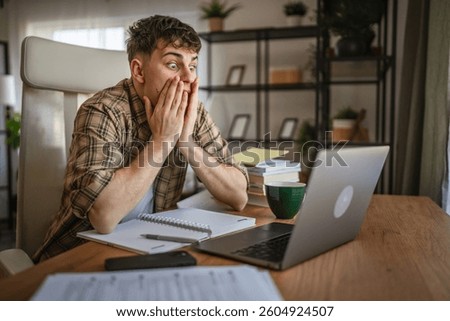 Angry man sit and work or study om laptop, show a confuse and trouble expression while sit at the table with computer