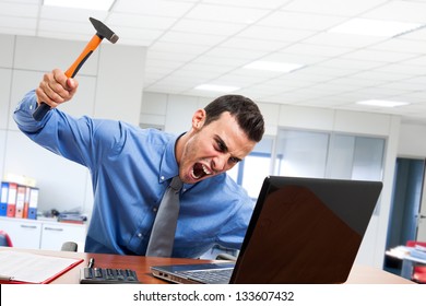 Angry man smashing his laptop