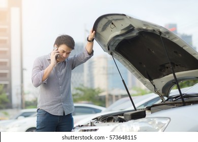 Angry man Stand front a broken car calling for assistance