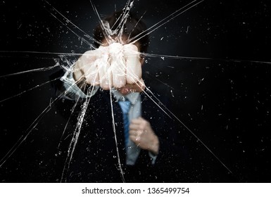 Angry Man In Suit And Tie Punch And Breaking Glass His Fist On Dark Background