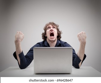 angry man swearing and cursing against information technology and his compuiter worries and hassles - concept of hating computers