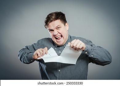 Angry man tear out paper