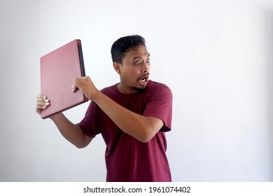 Angry Man Throwing Computer Or Laptop