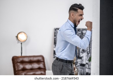 Angry Man Touching Wall With His Fist