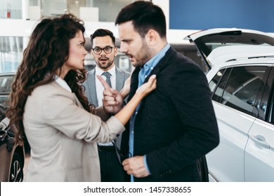 Angry Married Couple Is Discussing In A Car Sale Salon Or Showroom