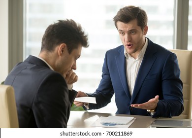 Angry mean boss yelling at employee for missing deadline, executive manager scolding ineffective salesman showing bad work results, firing worker for failure, team leader dissatisfied with report - Shutterstock ID 700211869