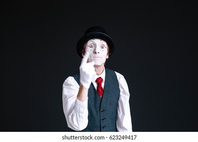 Angry mime holds his finger up in the air