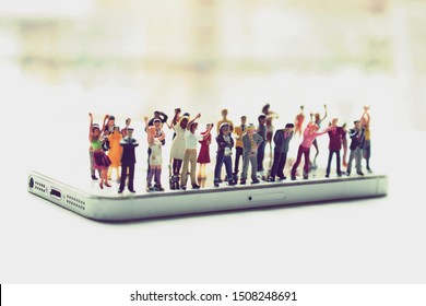 Angry Mob Of Various, Diverse People On A Phone. Social Media Addiction Concept Or People Mistreating One Another Online. Group Mentality Or Cancelled Culture. Men And Women Arguing Over Politics.