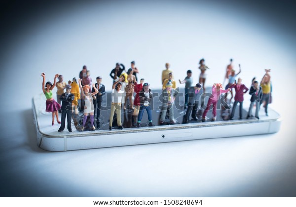 Angry mob of various, diverse people on a\
phone. Social media addiction concept or people mistreating one\
another online. Group mentality or cancelled culture. Men and women\
arguing over politics.