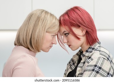 Angry Mother And Her Teen Daughter Look At Each Other Face To Face. Family Relationships. Concept Confrontation Of Generations 