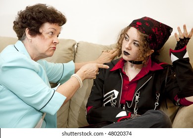 Angry Mother Pointing The Finger At Her Rebellious Teenage Daughter.  Focus On The Mom.