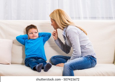 Angry Mother Is Scolding At Her Son.Family Conflict

