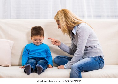 Angry Mother Is Scolding At Her Son.Family Conflict
