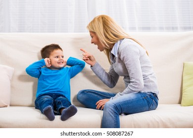 Angry Mother Is Scolding At Her Son.Family Conflict

