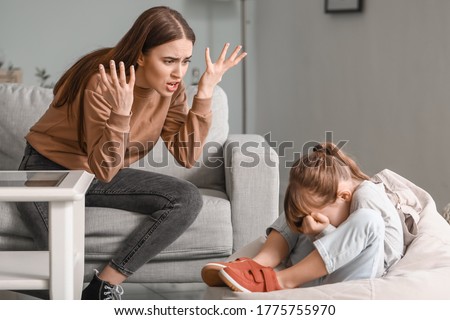 Angry mother threatening her daughter at home
