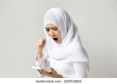 Angry Muslim Woman Using Smartphone With Negative Expression, Concept Of Online Scam, Internet Fraud, Bad Online Shopping Experience, Insecure Electronic Transaction, Poor Privacy Data Protection