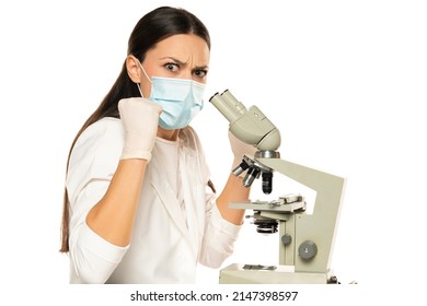 Angry Nervous Female Scientist With Protective Face Mask And Microscope, White Background.