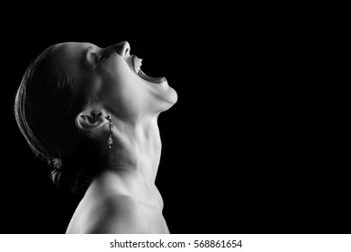 Angry Nude Girl Screaming Up On Black Background