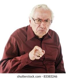 An angry old man glaring and pointing near the viewer.  Isolated on white.