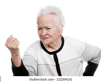 Angry old woman making a fist on white background