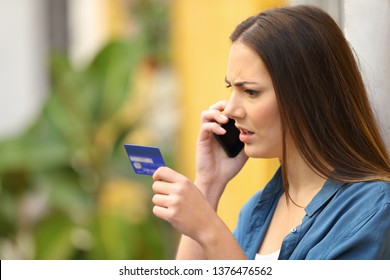 Angry Online Shopper Complaining Talking On Phone Holding Credit Card In The Street