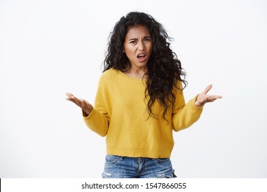 Angry and outraged african american curly-haired girlfriend freak-out, looking pissed as complaining, raise hands in dismay cringe from anger and disappointment, standing white background - Shutterstock ID 1547866055