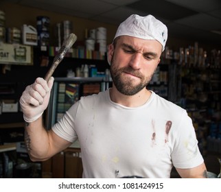 Angry Paint Store Employee Throwing Brush While Covered In Paint