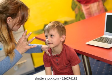 Angry parent forbids his kid to play games on the laptop - Powered by Shutterstock