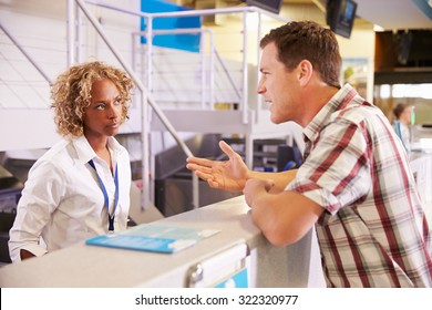 Angry Passenger Complaining To Staff At Airport Check In