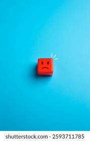Angry red face in the shape of a cube. Concept of irritation and anger. Irritation, frustration, rage, and emotional outbursts. Stress management. Aggressive emotions.