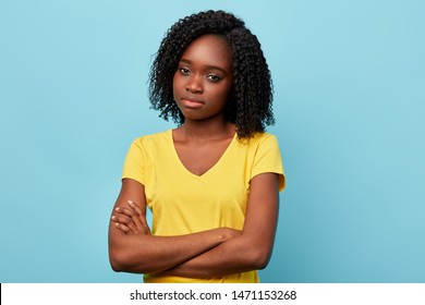 Angry Sad Frustrated Young Woman Dressed Casually Keeping Arms Folded, Looking At Camera With Skeptical Expression. Close Up Portrait.studio Shot.