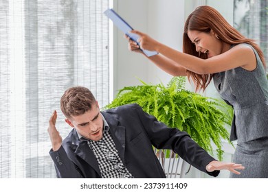 angry secretary hold document folder hit to boss head at the office after conflict argue meeting. Argue between boss and employee.