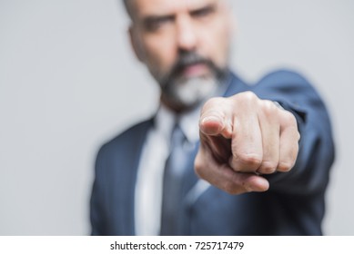 Angry senior man pointing his finger towards you, accusing and blaming