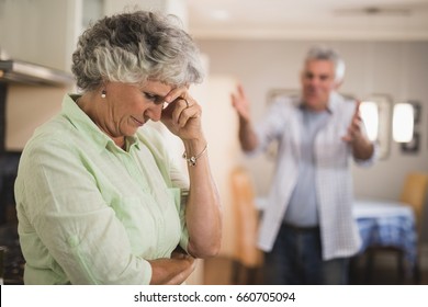 Angry senior man yelling on senior woman at home - Powered by Shutterstock